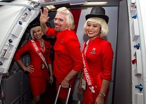 British billionaire Richard Branson (C) waves ...