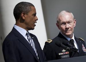 General Martin Dempsey (R) listens while US Pr...